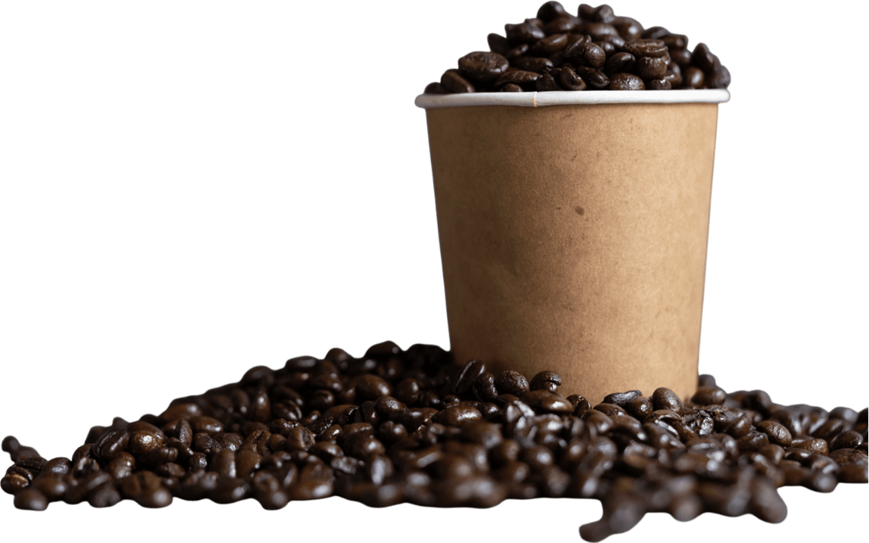 Coffee beans spilling from paper cup.