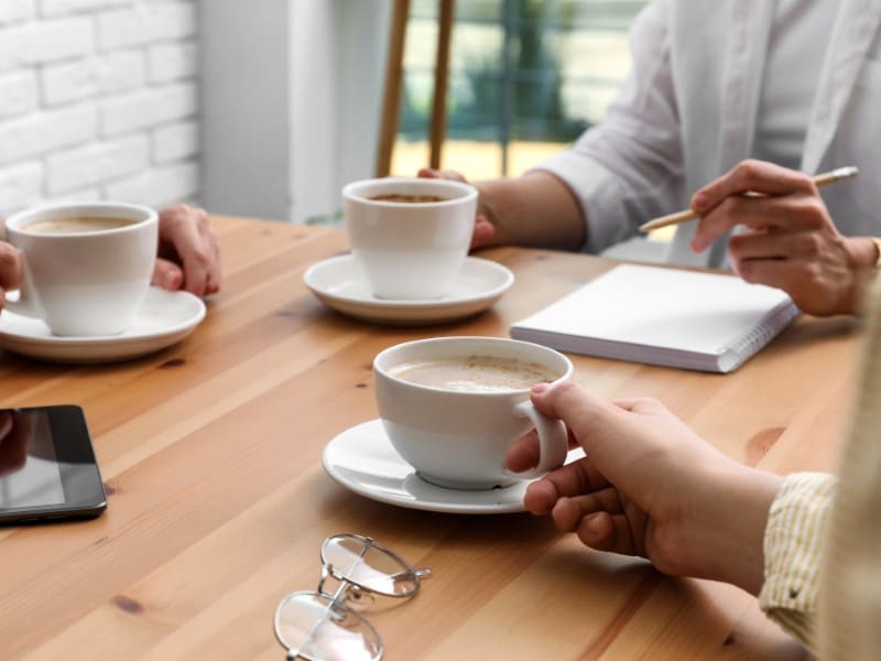 Coffee break meeting, notes and tablet.